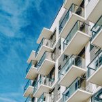 Detail of Modern residential apartment flat building exterior. Fragment of New luxury house and home complex. Part of City Real estate property and condo architecture. Copy space. Blue sky